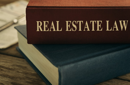 Law concept, real estate law books, antiquarian books pile on wood table.の写真素材