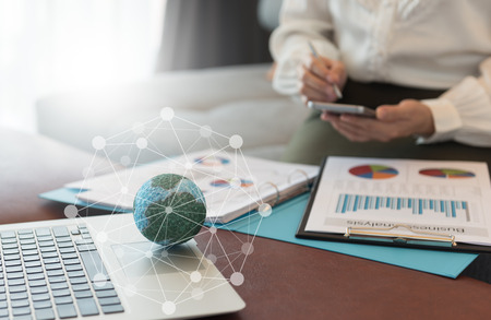 Mock up the globe with digital social media network on notebook with working women at office. Concept of Connection, Communication, Technology, Business and Financial Online. の写真素材