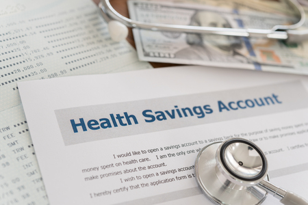 health savings account HSA concept with application form,dollar money, stethoscope, bank account on desk.の写真素材