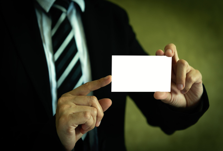 Businessman showing white business card in hand with clipping path on card.の写真素材