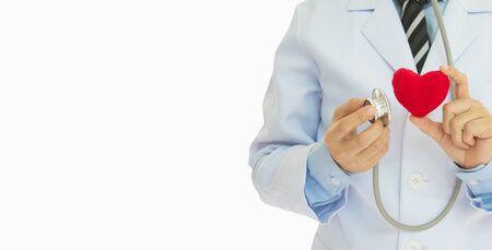 Medical heart health Concept. Doctor holding stethoscope check up heart at whiteの写真素材