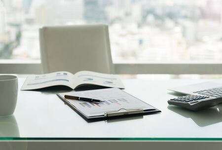 The report summarizes the results of business operations, pen, calculator on desk of investor.の写真素材