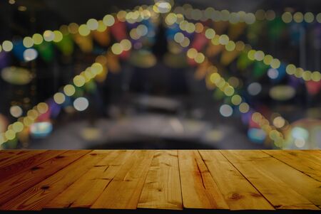 Christmas and New Year concept. Wooden table top with Christmas tree with decorations blurred from the celebration.の写真素材