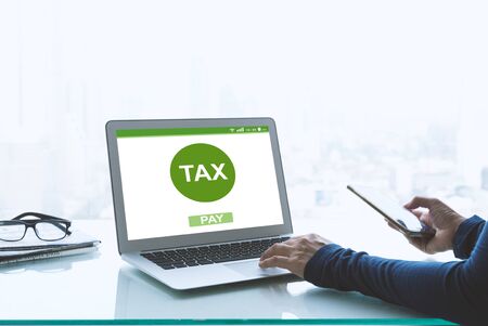 Filing taxes online using a laptop and the internet.の写真素材