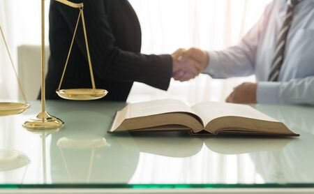 law, legal services concept. Female lawyer handshake with client for legal adviser.の写真素材