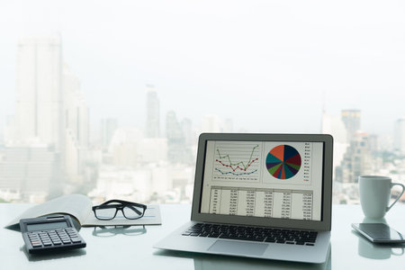 Business earning report and financial chart and graph report in screen laptop computer on office...