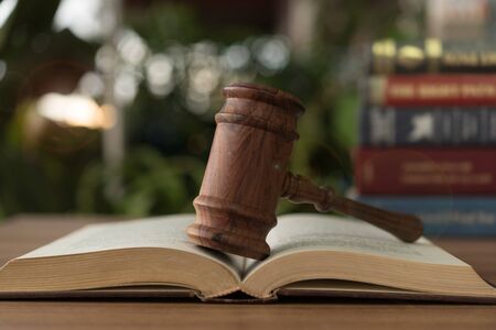 Judges gavel resting on open law books.  concept of legal ruling Jurisprudence, law education.の写真素材