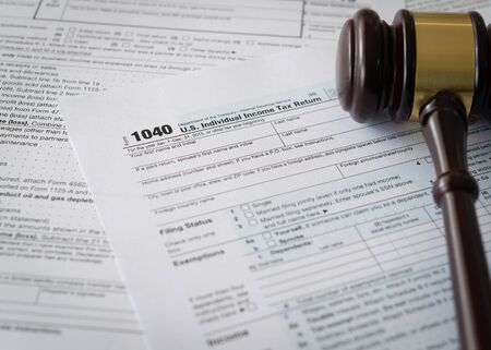 Judge gavel on individual income tax return form.の写真素材