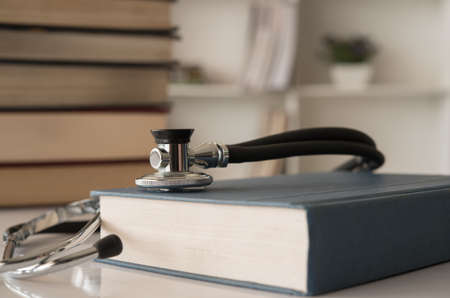 stethoscope on medical guide book for doctor learning treatment at hospital.  medical education learning concept.の写真素材