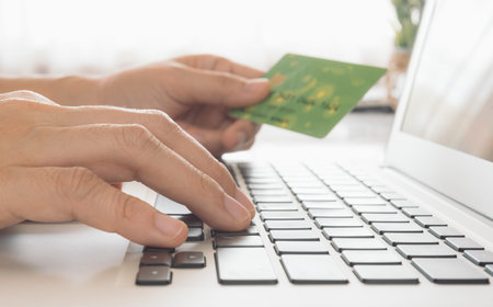Women use laptops and credit cards to order and make payments online. Technology Concepts and Modern...