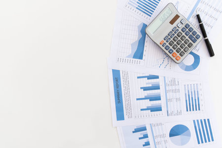 above view of office desk with calculator on business and financial report with copy space. Concept...