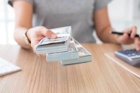 personal loan,insurance claim, finance concept. women staff giving money banknote.