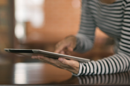 Woman's using a tablet computer at home. Concept of Communication, Networking, Technology