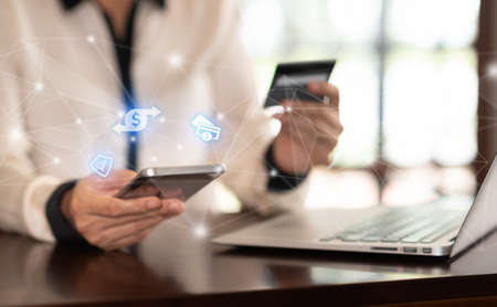 Businesspeople using a smartphone, transfer money, pay for goods and services with a secure protection system. Mobile banking network.の写真素材