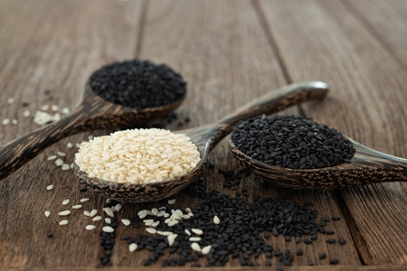 White sesame and Black sesame seed on wooden spoon. Healthy food and drink concept.の写真素材