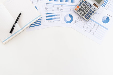 top view of office desk with calculator on business and financial report with copy space. Concept of  accounting audit, business analysis,financial planning.の写真素材