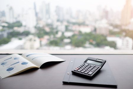 calculator on report financial the results of business operations on desk of investor.の写真素材