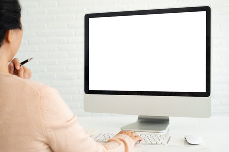 Close-up of a young woman using a computer. Blank screen for your advertisement. With a clipping...
