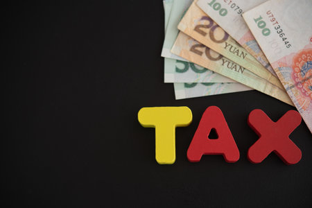 âTaxâ word, wooden letters on the banknote. Tax Concept.の写真素材