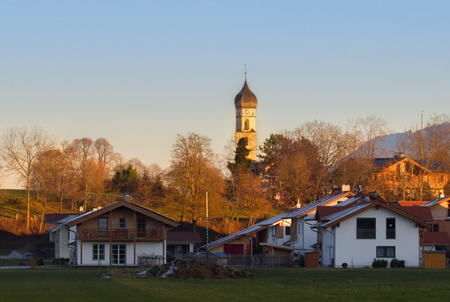 The last rays of sunlight of the day shine over the village.の写真素材
