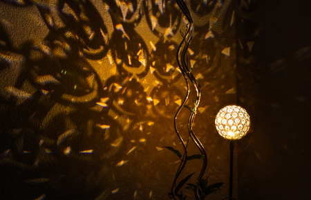 Night light shines shapes on the wall.の写真素材