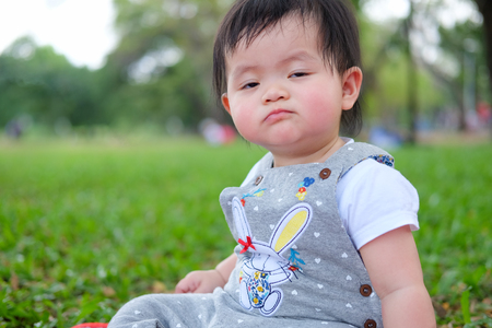 Cute Baby girl playing in the garden, close-up portrait, Portrait of a beautiful baby girlの写真素材