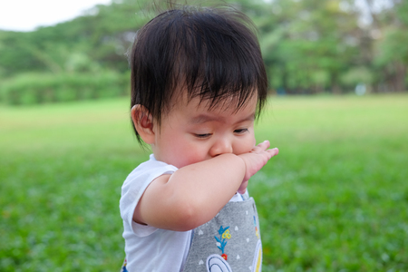 Cute Baby girl playing in the garden, close-up portrait, Portrait of a beautiful baby girlの写真素材