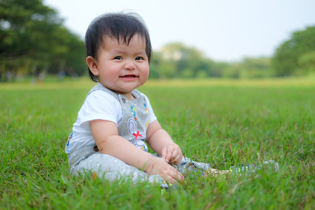Cute Baby girl playing in the garden, close-up portrait, Portrait of a beautiful baby girlの写真素材