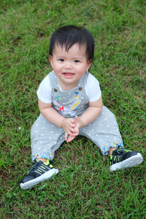 Cute Baby girl playing in the garden, close-up portrait, Portrait of a beautiful baby girlの写真素材