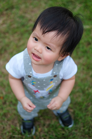 Cute Baby girl playing in the garden, close-up portrait, Portrait of a beautiful baby girlの写真素材