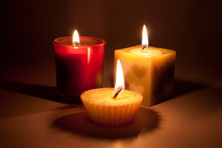 3 candles light in darkの写真素材