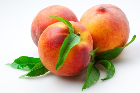 Juicy Peaches with leaves. Fruits Isolated on White Backgroundの写真素材