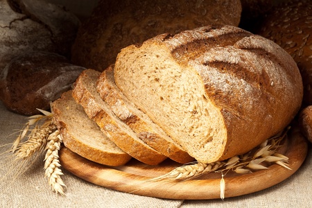 fresh-baked bread on wooden plateの写真素材