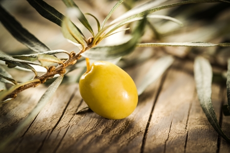 Organic olive over Wooden Backgroundの写真素材