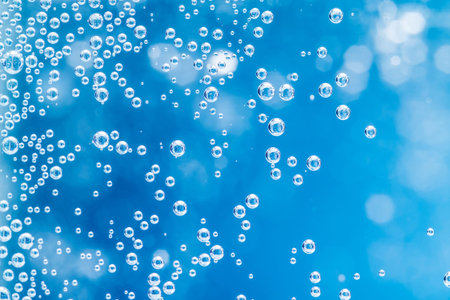 Macro bubbles of water on blue background