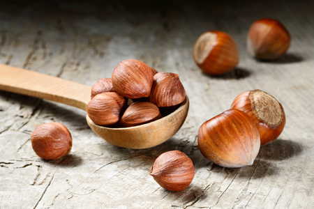 Hazelnut. Fresh organic filbert on wooden background. Nuts macro.の写真素材