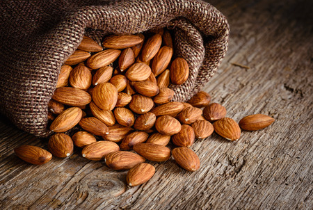 Almonds on textured woodenの写真素材