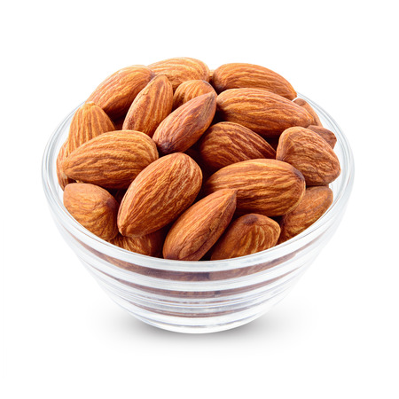 Almond. Nuts in a bowl isolated on white. Full depth of field.の写真素材