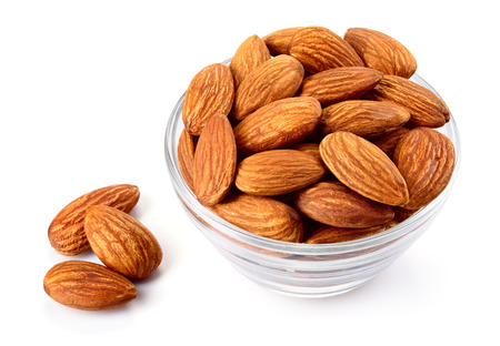 Closeup of almonds. Almonds in a bowl isolated on white background. Full depth of field.の写真素材