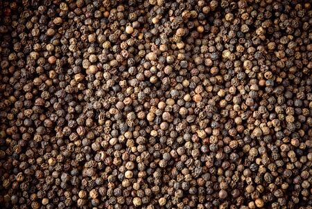 Peppercorn background. Dry black pepper seeds. Top view.の写真素材