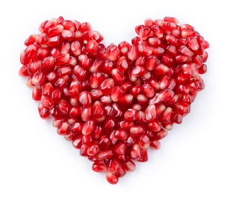 Pomegranate isolated. Pomegranate seeds on white background. Heart shape.の写真素材