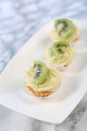 Board with delicious cake on tableの写真素材