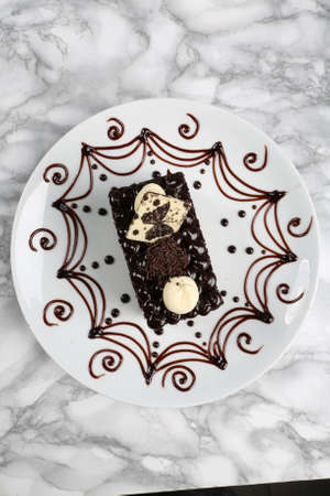 Board with delicious cake on tableの写真素材