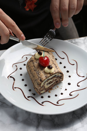 Board with delicious cake on table