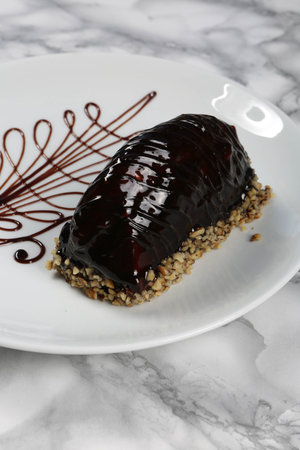 Board with delicious cake on table