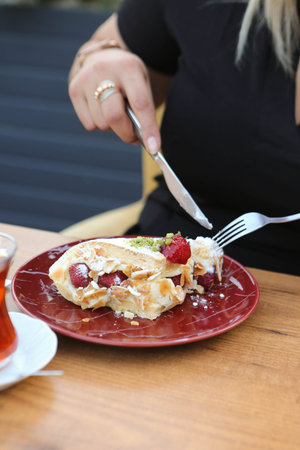 Board with delicious cake on table