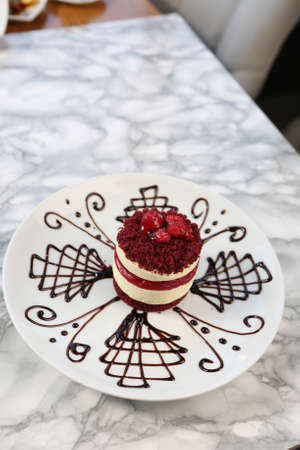 Board with delicious cake on tableの写真素材