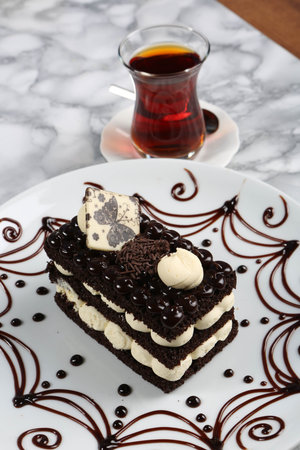 Board with delicious cake on table