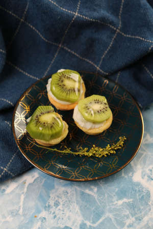 Board with delicious cake on tableの写真素材