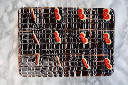 Board with delicious cake on tableの写真素材